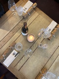 A table adorned with wine glasses and a glowing candle, enhancing the ambiance for a special occasion
